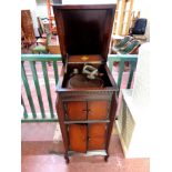 An early 20th century oak cased Gilbert gramophone in cabinet with a small quantity of 78's