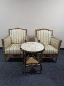 A pair of 20th century wicker armchairs upholstered in a Regency striped fabric together with a