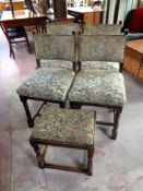 A set of four 20th century dining chairs upholstered in a tapestry fabric together with a similar