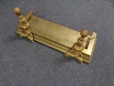 A 19th century brass fire curb with fixed fire dog.