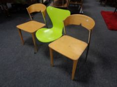 An Arne Jacobsen designed Fritz Hansen series 7 chair in green on metal legs together with a pair