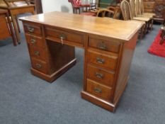 A 19th century walnut kneehole desk, fitted nine drawers, with brass drop handles.