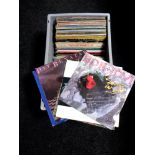 A box of vinyl LP's and 12" singles, Joan Baez, Stevie Wonder, Wings,