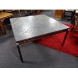 A mid 20th century square Danish coffee table with an etched metal panel top.