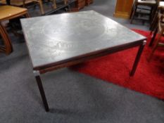A mid 20th century square Danish coffee table with an etched metal panel top.