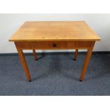 A 20th century pine writing table, fitted a drawer.