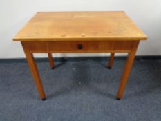 A 20th century pine writing table, fitted a drawer.