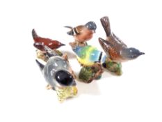 Nine Beswick bird ornaments to include bullfinch, blue tit, wren, green finch etc (as found).