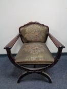 An early 20th century mahogany framed armchair on X-frame support upholstered in a tapestry fabric.