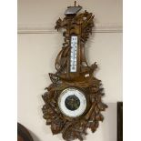 An early 20th century heavily carved nautical themed barometer by L. Meumann.