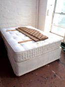 A Sleepeezee 4' 6" storage divan and interior together with a headboard