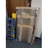 A boxed chrome wall mounted towel radiator.