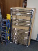 A boxed chrome wall mounted towel radiator.