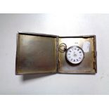A silver cigarette case together with a silver fob watch.