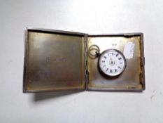 A silver cigarette case together with a silver fob watch.