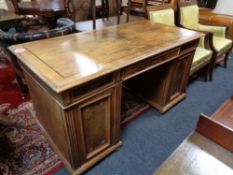 A 19th century walnut twin pedestal writing desk, fitted three drawers.