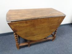 An early 20th century oak barley twist gate leg table.