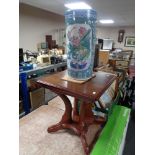 A contemporary pedestal occasional table together with a glazed pottery Chinese style stick pot.