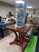 A contemporary pedestal occasional table together with a glazed pottery Chinese style stick pot.