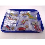 A tray containing eleven World War II medals, nine with ribbons to include 1939-45 Star,