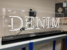 A 'Denim' neon sign in perspex case.