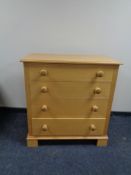 A four drawer chest with knob handles.