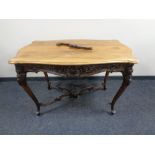 An early 20th century shaped walnut drawing room table on carved cabriole legs (under stretcher