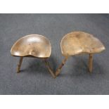 Two rustic milking stools.