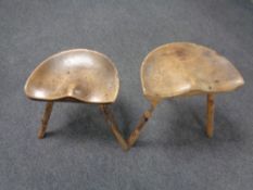 Two rustic milking stools.