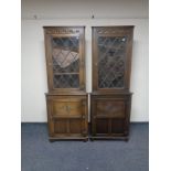 A pair of Jaycee oak leaded glass door corner cabinets, fitted cupboards beneath.