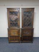A pair of Jaycee oak leaded glass door corner cabinets, fitted cupboards beneath.