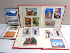 A crate containing four albums of 20th century postcards and photographs.