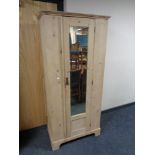 A Victorian pine mirror door wardrobe