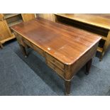 A continental mahogany five drawer writing desk