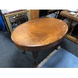 A continental carved mahogany oval occasional table