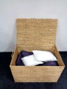 A wicker hamper containing two John Lewis bed throws, curtain tie backs, other soft goods etc.