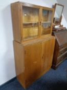 A teak Staples ladderax unit (lacking shelves) together with a double door storage cabinet and one