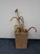 A wicker basket containing walking canes,