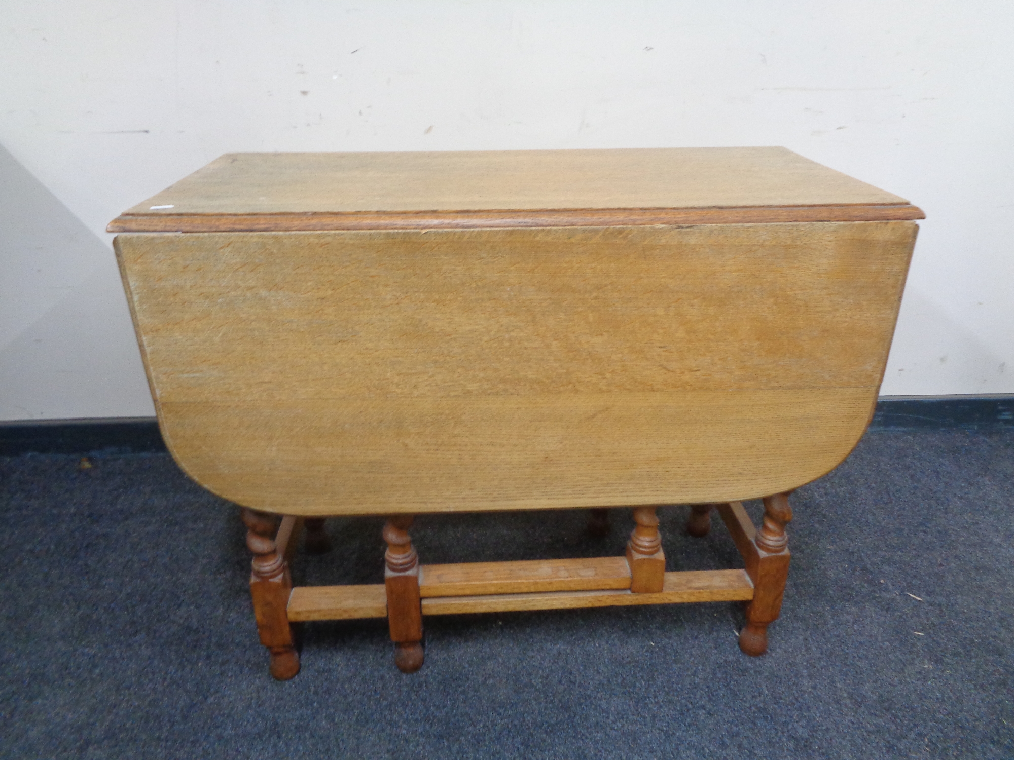 An oak drop leaf table on barley twist legs