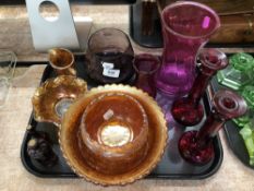 A tray containing carnival glassware, Caithness purple glass vase, pair of candlesticks,
