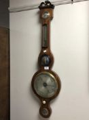 An early 19th century mahogany cased banjo barometer with silvered dial