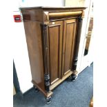 A continental mahogany double door cabinet with pillar supports