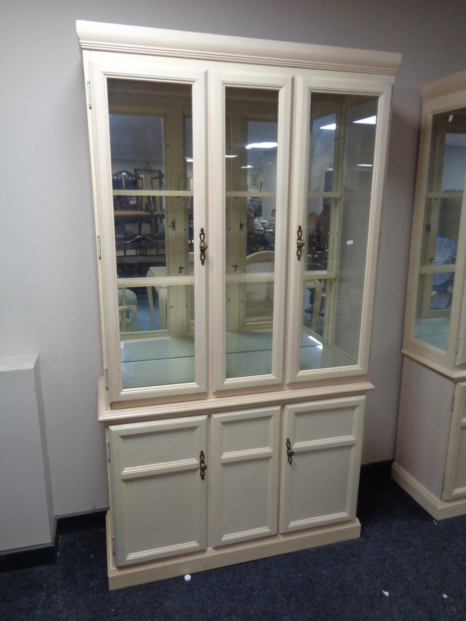 A contemporary glazed mirrored back display cabinet