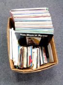 A box containing vinyl LPs and 45 singles, folk and country music.