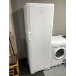 An Indesit upright fridge