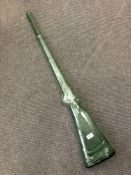 A green glass ornament/ vessel modelled as a rifle, overall length 114 cm.