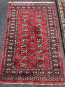 An Afghan Tekke rug on red ground 152 x 95 cm