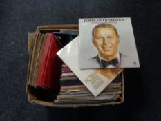 A box containing a large quantity of vinyl LP records, Frank Sinatra, Bony M, Abba etc.