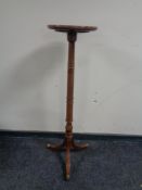 A turned mahogany wine table raised on brass castors