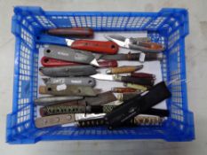 A box containing a collection of Stanley knives, pocket knives,
